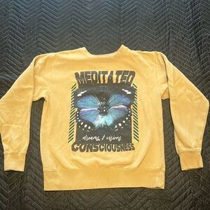 Size: medium
Clothing type : crew neck
Color : tan , beige yellow with decals